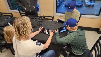 A family playing games on the Steam Deck together.